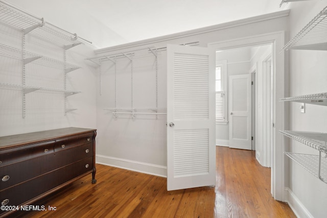 spacious closet featuring hardwood / wood-style floors