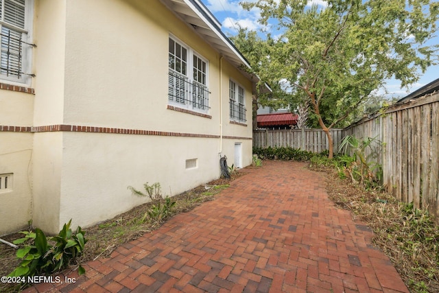 view of side of home featuring a patio