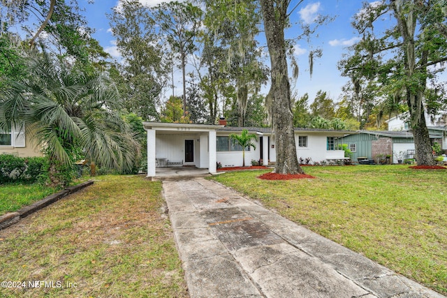 ranch-style house with a front lawn and a carport