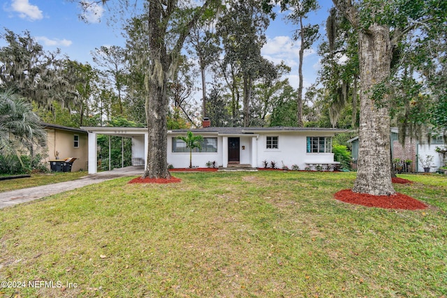 single story home featuring a front yard and a carport