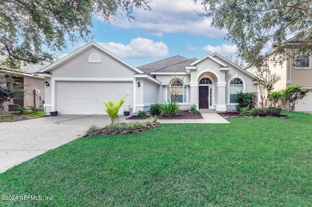 ranch-style house with a front lawn and a garage