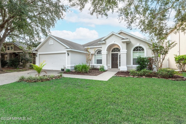 single story home with a garage and a front yard