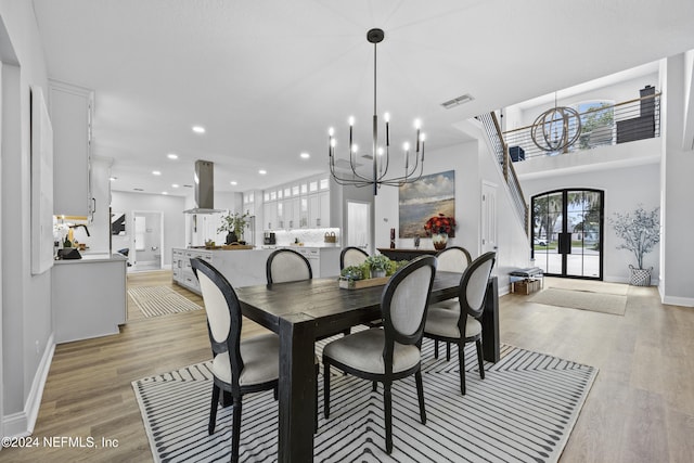 dining room featuring a chandelier and light wood-type flooring