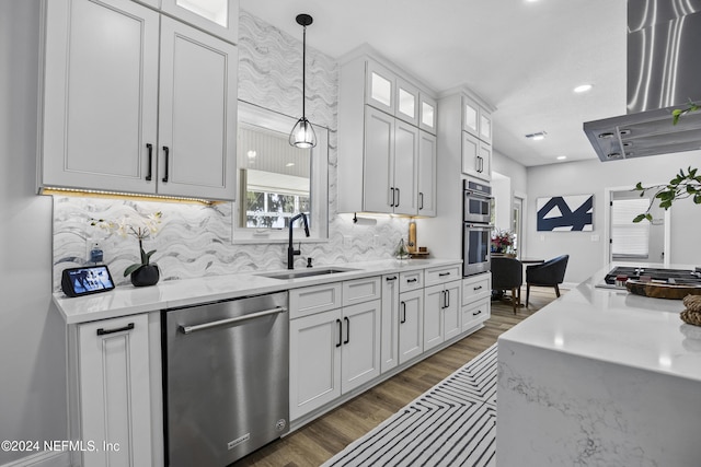 kitchen with white cabinetry, hanging light fixtures, extractor fan, and appliances with stainless steel finishes