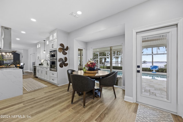 dining area with light hardwood / wood-style flooring and sink