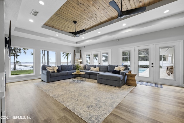 living room with ceiling fan, light hardwood / wood-style flooring, and french doors