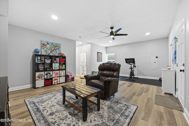 living room with hardwood / wood-style floors and ceiling fan