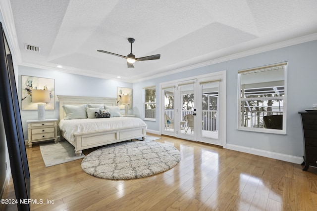 bedroom with access to outside, ceiling fan, a textured ceiling, and light wood-type flooring