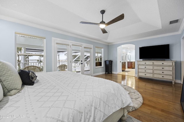 bedroom featuring access to outside, multiple windows, ceiling fan, and dark wood-type flooring