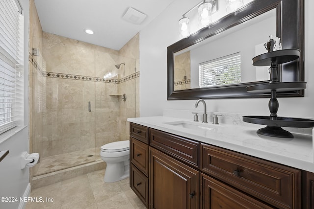 bathroom with tile patterned floors, vanity, toilet, and a shower with door