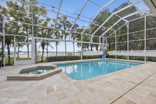 view of pool featuring a lanai, an in ground hot tub, and a patio