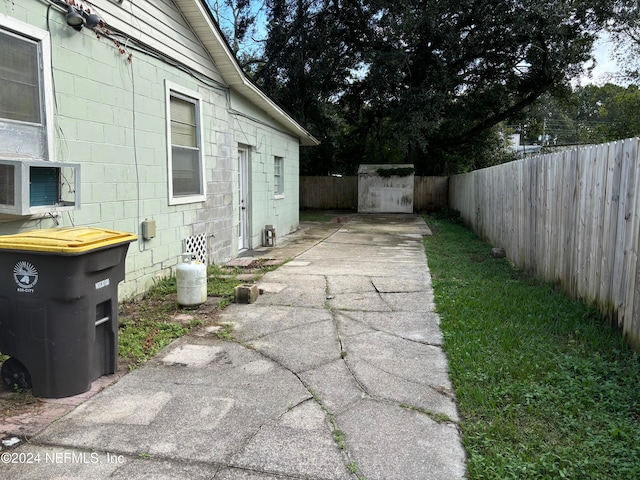 view of yard with a storage unit and cooling unit