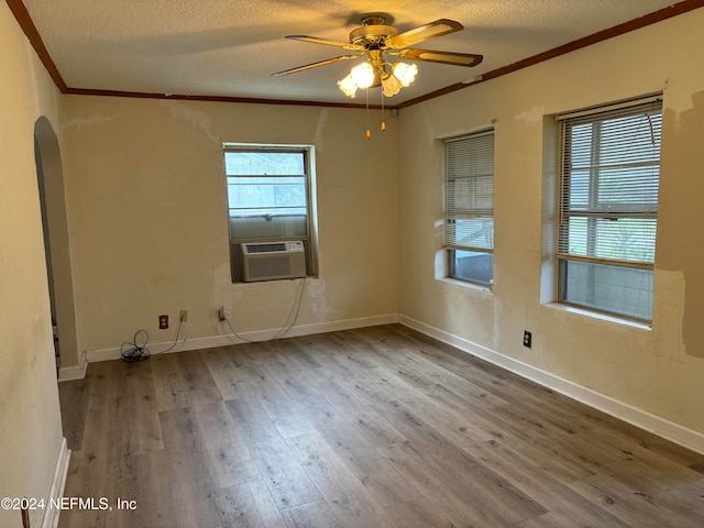 unfurnished room featuring a textured ceiling, ceiling fan, wood-type flooring, and ornamental molding