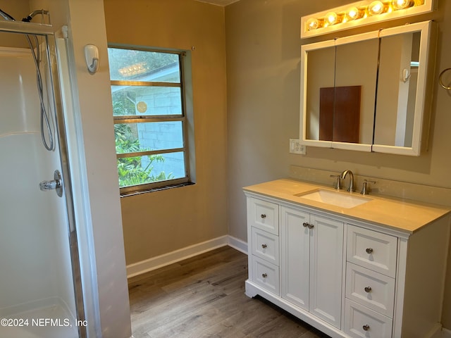 bathroom with vanity and hardwood / wood-style flooring