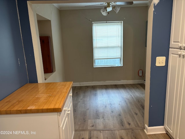 unfurnished dining area with dark hardwood / wood-style flooring and ceiling fan