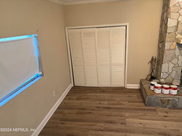 interior space with dark hardwood / wood-style flooring and ornamental molding