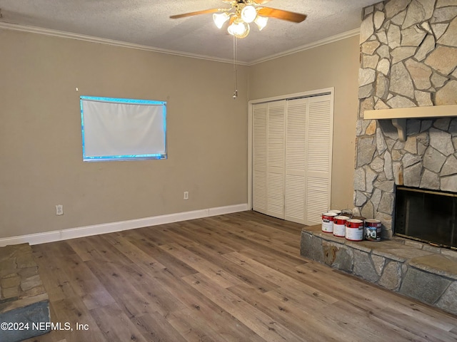 unfurnished bedroom with wood-type flooring, a textured ceiling, a closet, and crown molding