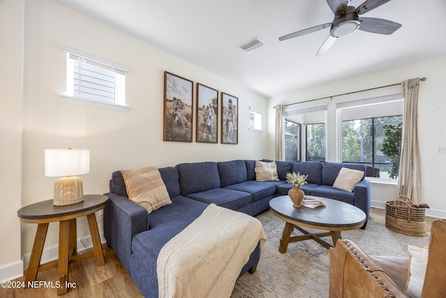 living room with wood-type flooring and ceiling fan