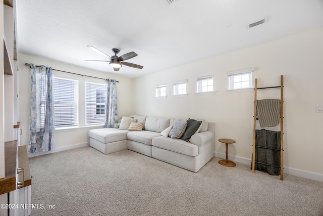 living room with carpet floors, plenty of natural light, and ceiling fan