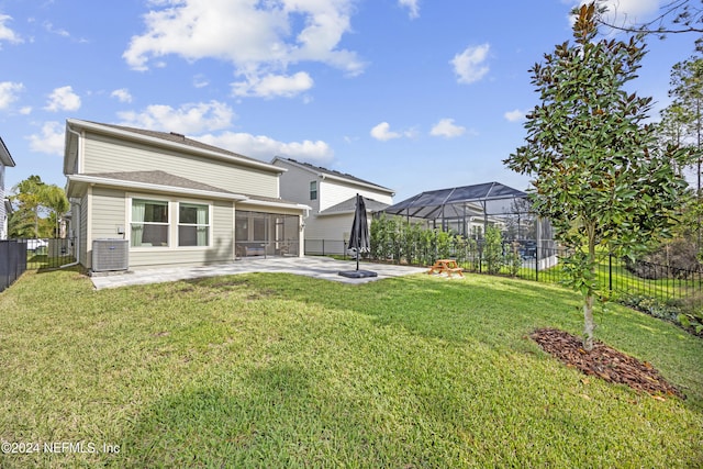 back of property featuring a lawn, central AC, and a patio