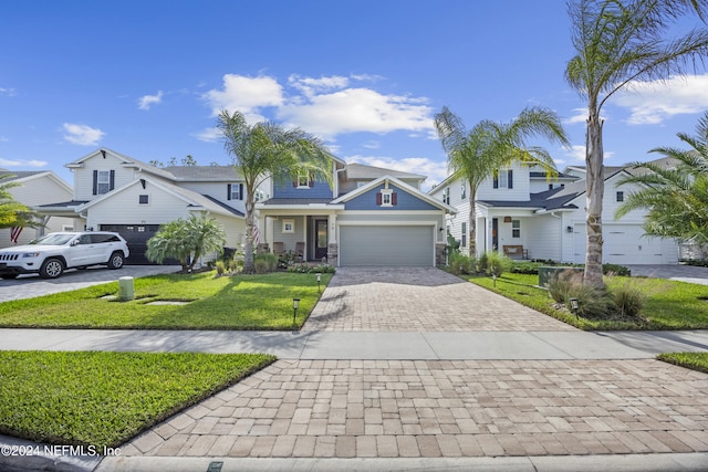 view of front of home featuring a front yard and a garage