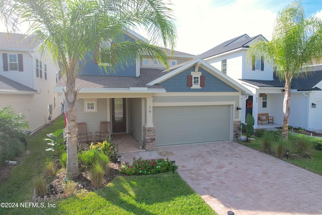 craftsman inspired home featuring a porch and a garage