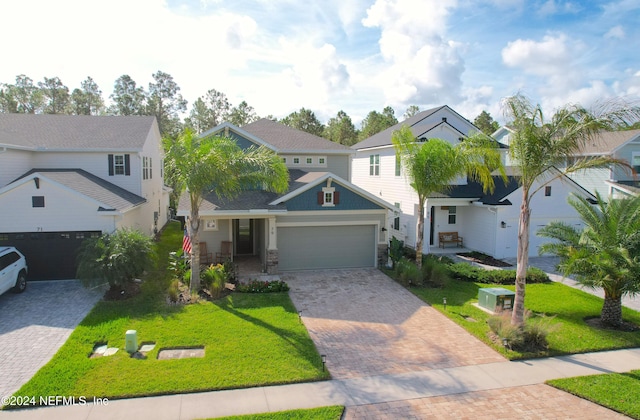 view of front of property with a front yard and a garage