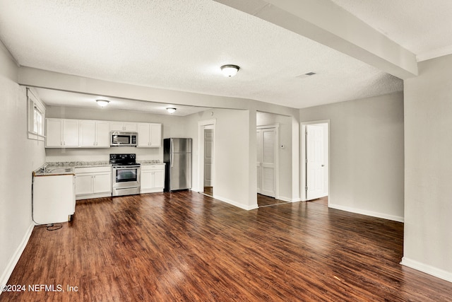 kitchen with white cabinets, dark hardwood / wood-style flooring, stainless steel appliances, and a textured ceiling