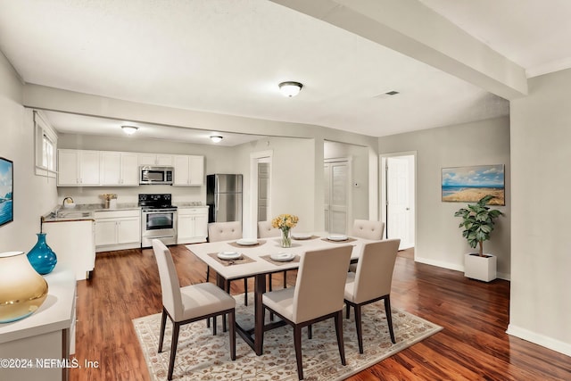 dining area with dark hardwood / wood-style floors and sink