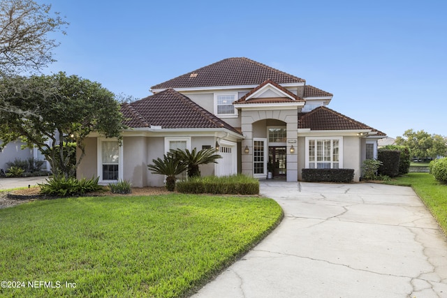 view of front of home with a front yard and a garage