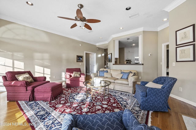 living room with ceiling fan, hardwood / wood-style floors, and ornamental molding