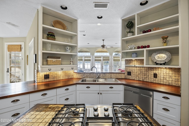 kitchen with decorative backsplash, butcher block countertops, white cabinetry, and a wealth of natural light