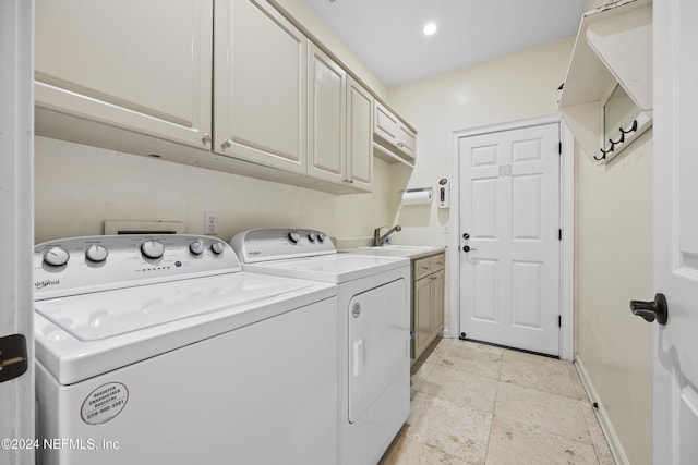 laundry area featuring cabinets, sink, and washing machine and clothes dryer