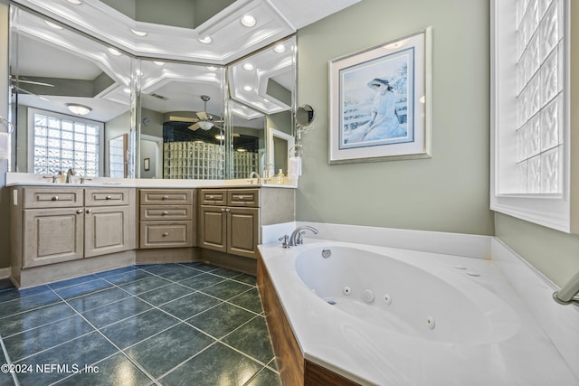 bathroom with vanity, tile patterned floors, ceiling fan, ornamental molding, and a tub