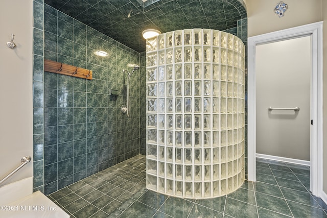 bathroom with tile patterned floors and a tile shower