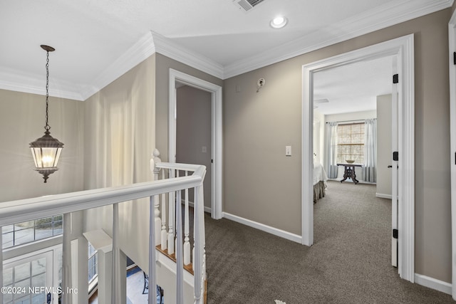 hall featuring dark carpet and ornamental molding