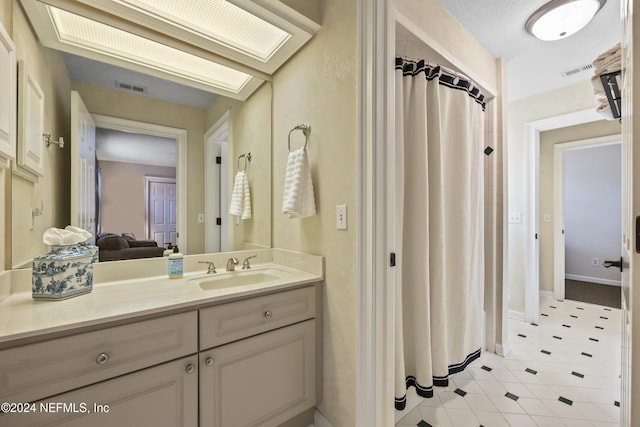 bathroom featuring tile patterned flooring, vanity, and a shower with curtain