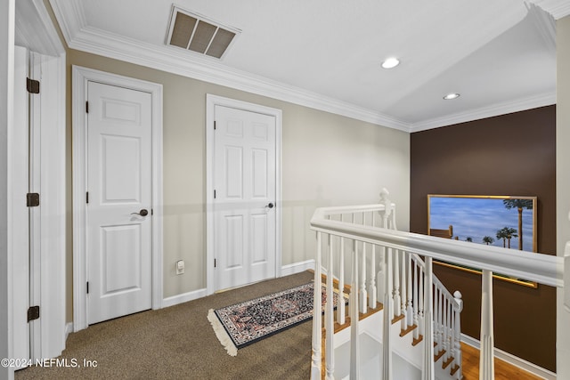 hall featuring carpet and ornamental molding