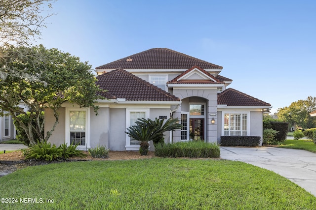 mediterranean / spanish home featuring a front yard