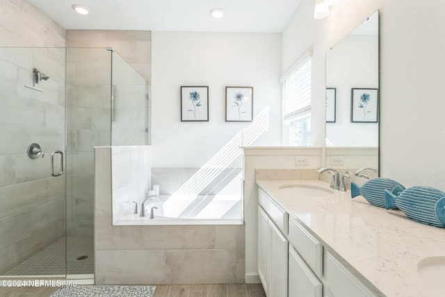 bathroom with vanity, hardwood / wood-style flooring, and separate shower and tub