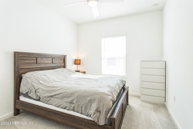 bedroom featuring ceiling fan and light colored carpet