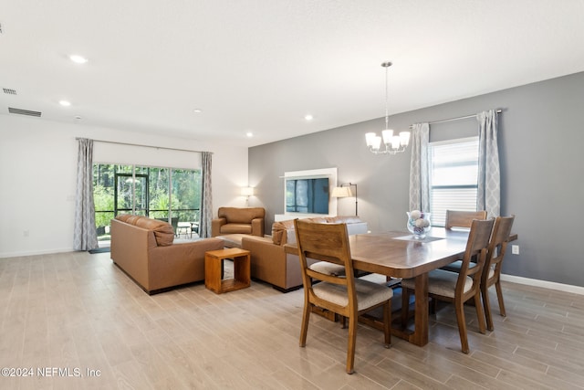 dining room featuring a chandelier and light hardwood / wood-style floors