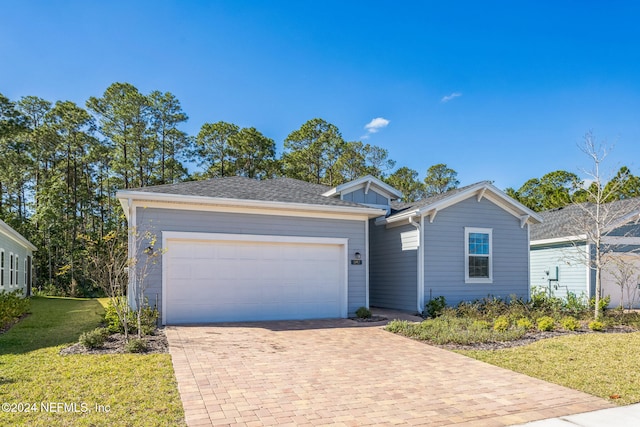 single story home featuring a garage and a front lawn