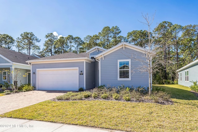 view of front of property featuring a garage and a front lawn