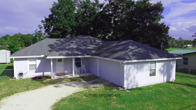 ranch-style home with a yard and a garage