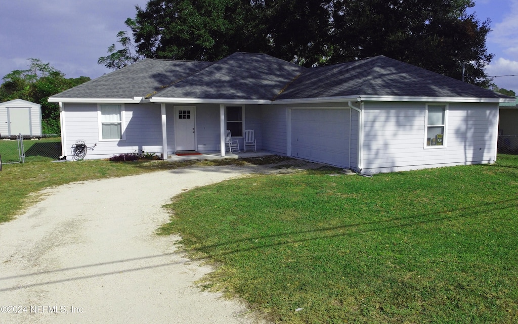 ranch-style house with a front lawn and a garage