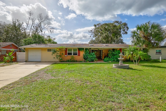 ranch-style house featuring a garage and a front lawn