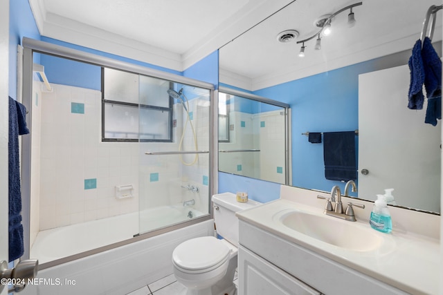 full bathroom with crown molding, toilet, bath / shower combo with glass door, and vanity