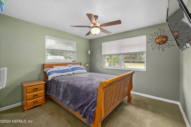 bedroom featuring ceiling fan and carpet