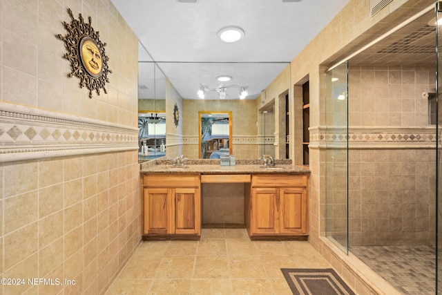 bathroom featuring vanity, tile walls, and walk in shower